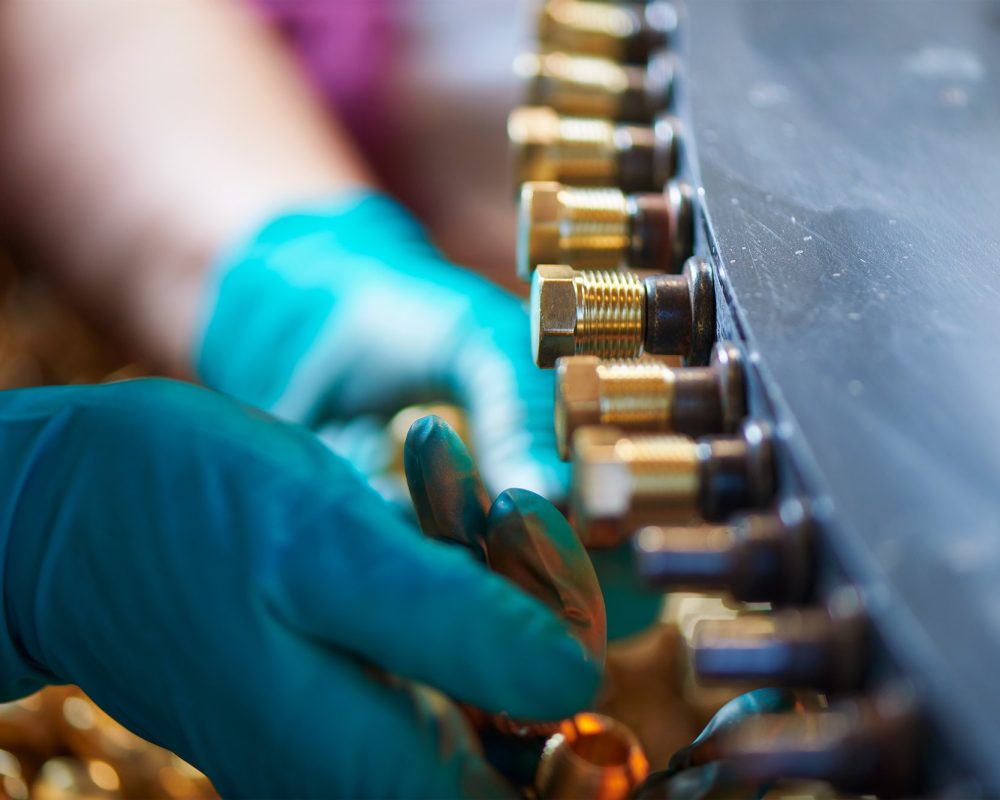 Loctite adhesive being applied to screws